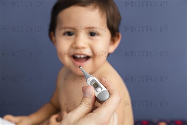 Close up doctor holding thermometer