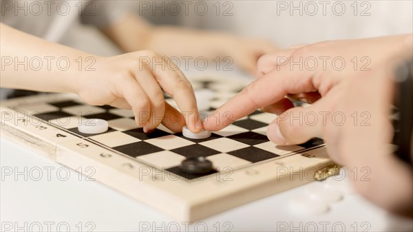 Close up kid playing chess