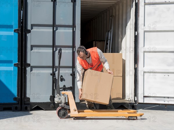 Full shot man carrying box