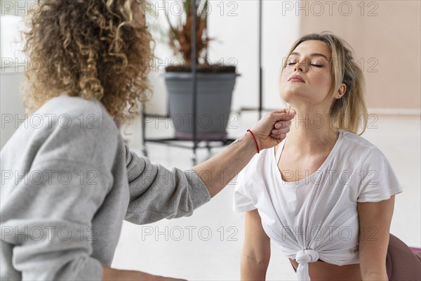 Teacher helping woman with pose_3