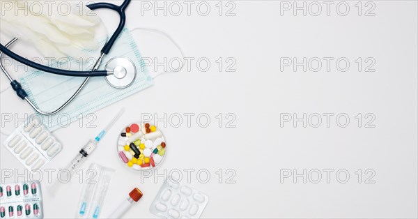 Top view stethoscope with syringe pills