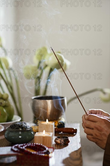 Side view man holding incense stick