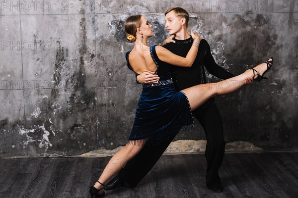 Woman performing split during passionate partner dance