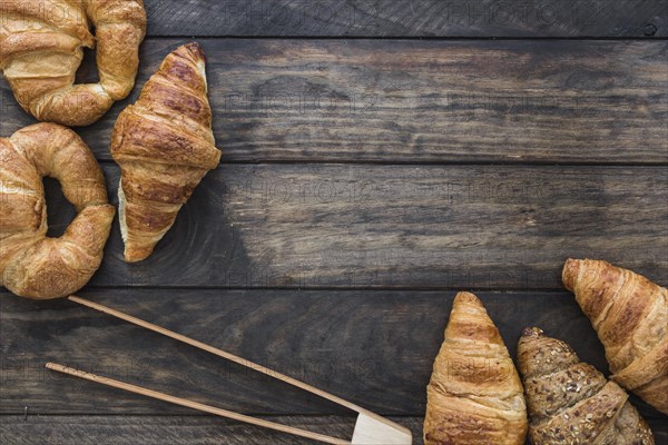 Wooden tongs near croissants