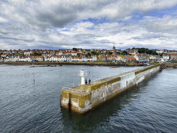 Aerial view of the fishing village of Pittenweem on the Firth of Forth with quay wall and lighthouse