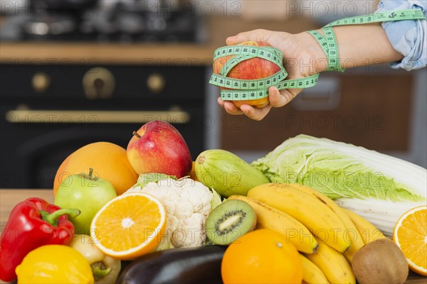 Close up person with fruits arrangement