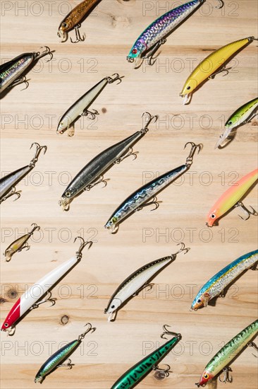 Diagonal colorful fishing lures wooden surface