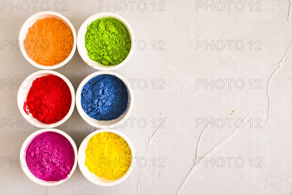 Arranged bowls holi color powder concrete backdrop