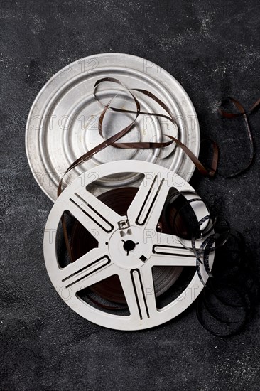 Film reel canister with negative stripes dark background