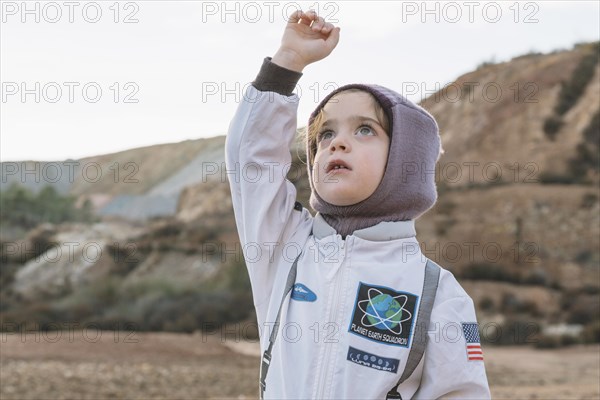 Little girl spaceman suit nature