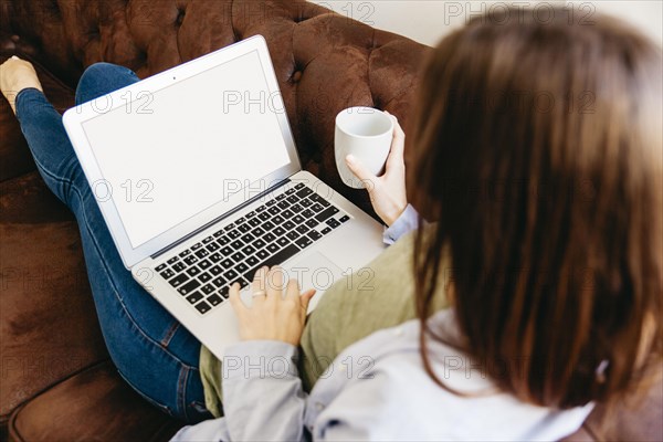 Girl relaxing with drink laptop