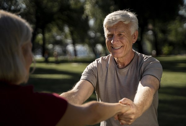 Smiley older couple exercising outdoors