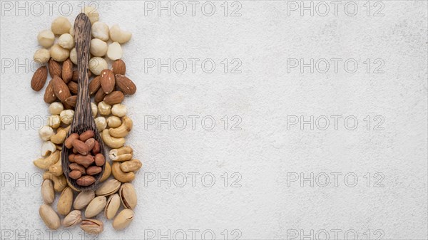 Different kinds nuts spoon copy space