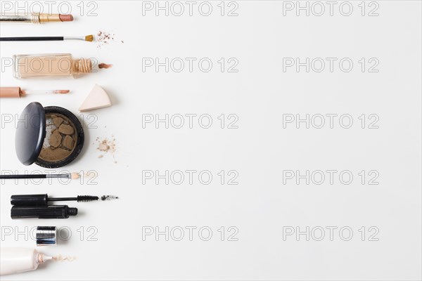 Makeup products arranged gray background