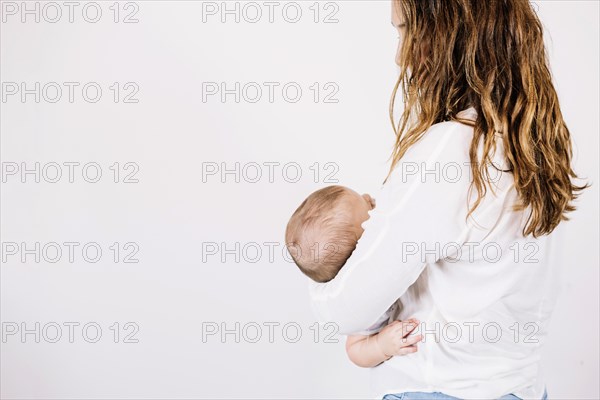Unrecognizable woman holding baby