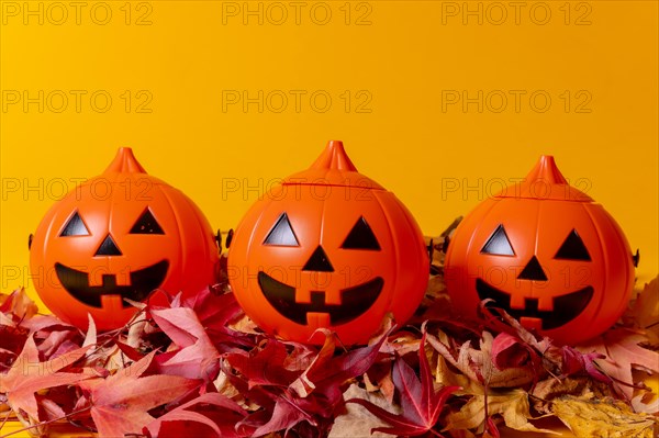 Halloween orange pumpkins on a yellow background