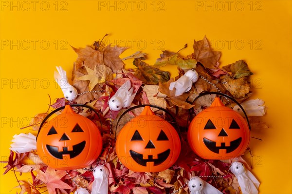 Overhead view of orange Halloween pumpkins on a background of yellow