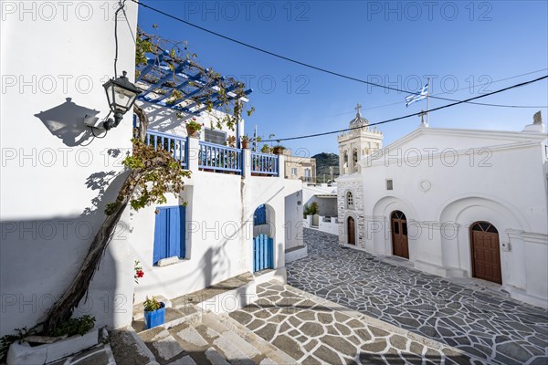 White Cycladic houses with blue doors and Christ Church