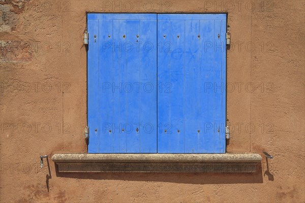 Window with closed blue shutters