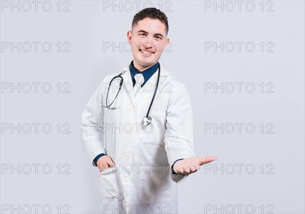 Friendly doctor extending hand in welcome isolated. Happy doctor extending hand to camera. Cheerful doctor extending hand welcome