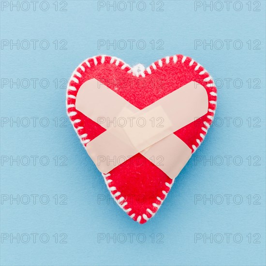 Bandage white stitch red heart shape blue background