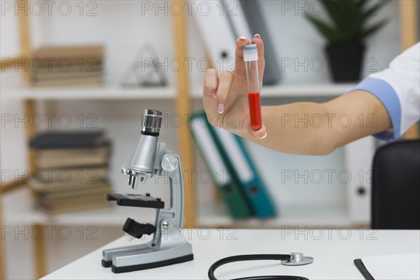 Female doctor hand holding blood sample