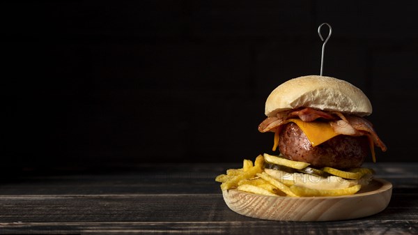 Front view cheeseburger fries wooden tray with copy space