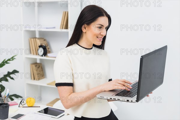 Woman using laptop office