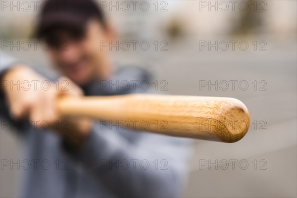 Defocused man holding baseball bat