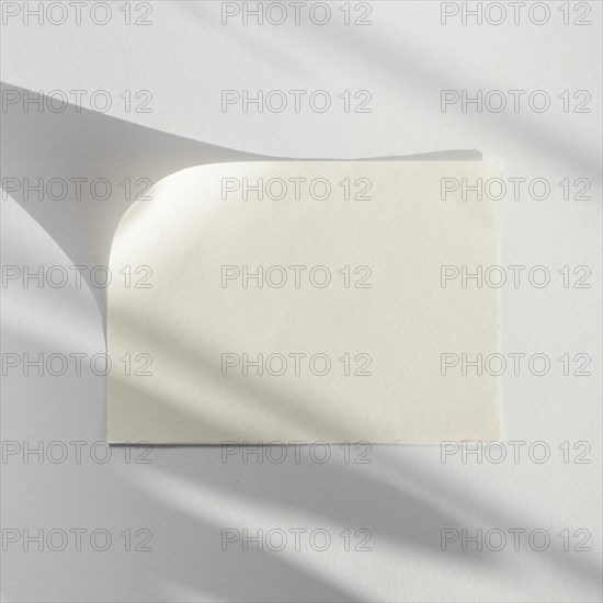 White background with white blank paper with its shadow
