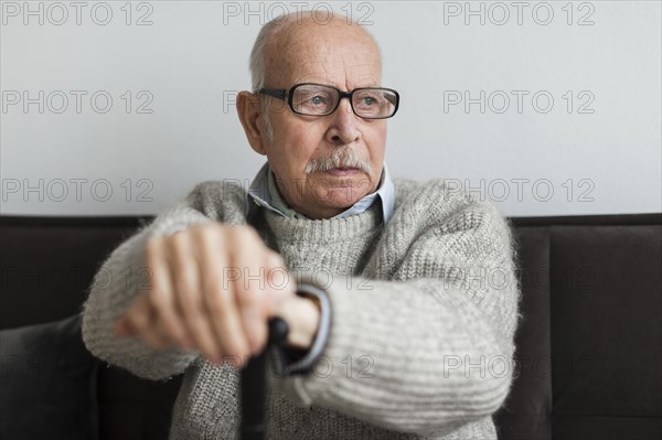 Old man nursing home with glasses cane