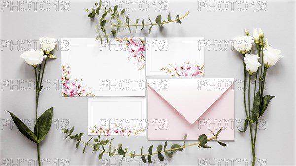 Flowers beside wedding invitation