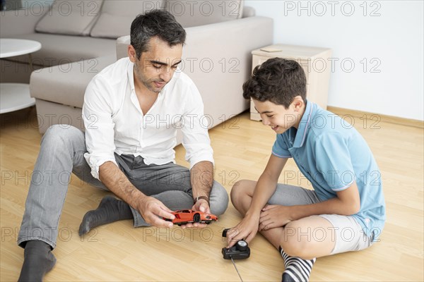 Father child playing with electric car