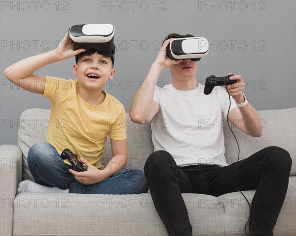 Front view boy man playing video games with virtual reality headset