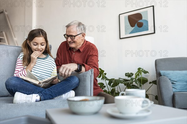 Grandfather girl reading together