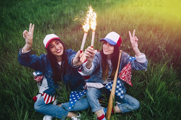 Women with fireworks hands smiling