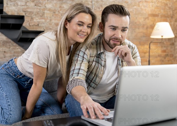 Couple home having videocall with family