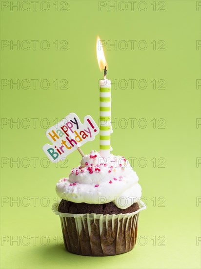 Muffin with candle happy birthday sign