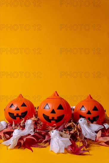 Halloween orange pumpkins on a background of yellow