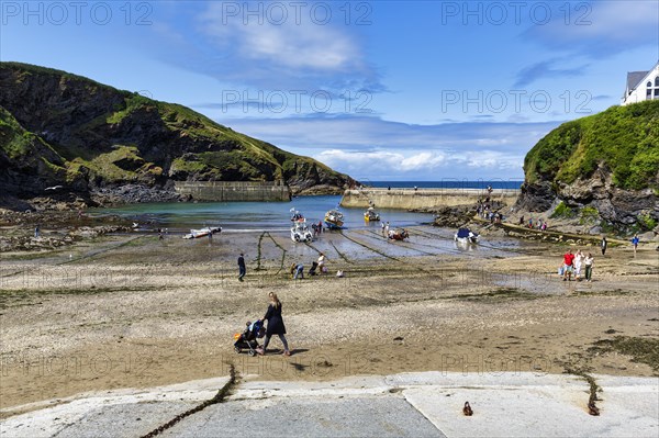 Pedestrians in the harbour at low tide