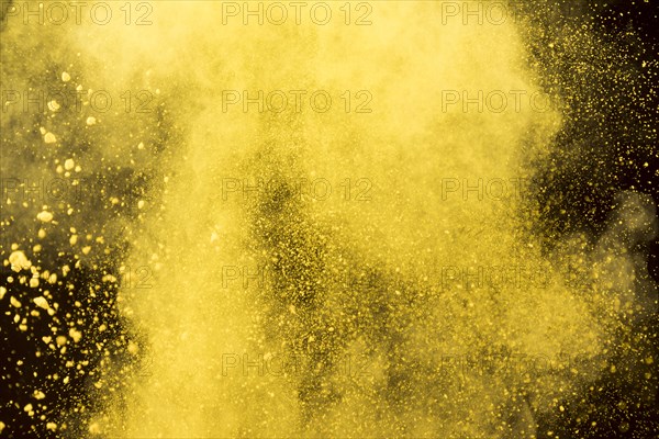 Yellow cloud cosmetic powder black background