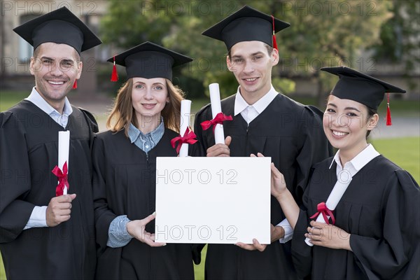 Graduation concept with students holding blank certificate template