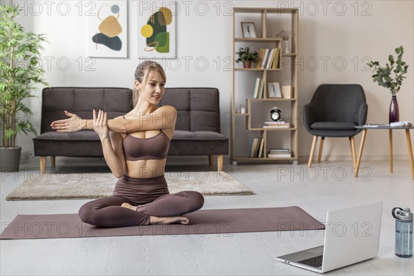 Young woman exercising home mat