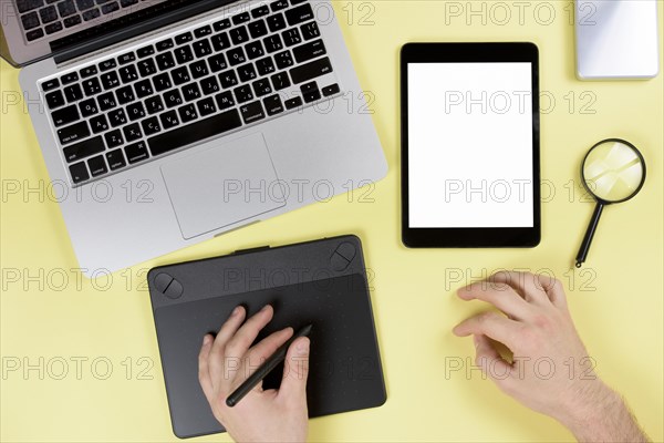 Designer working graphic digital tablet with stylus yellow desk