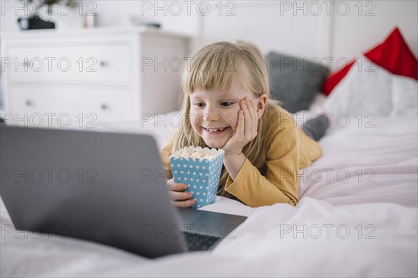 Girl with popcorn watching film