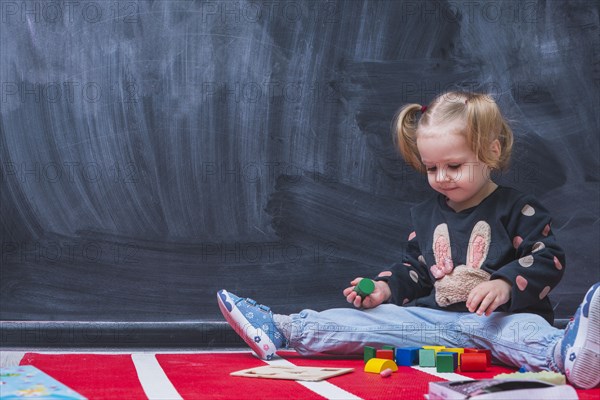 Cute girl playing with toys