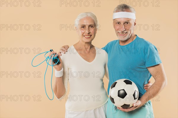 Modern senior couple with skipping rope football
