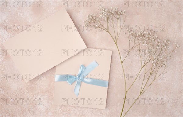 Pink arrangement with wedding invitation