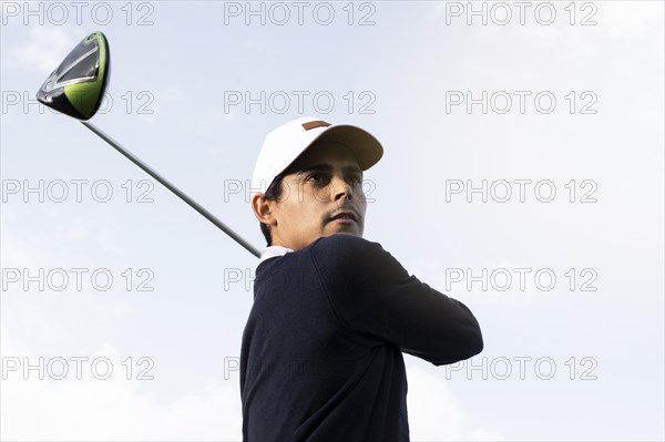 Low angle man with golf club