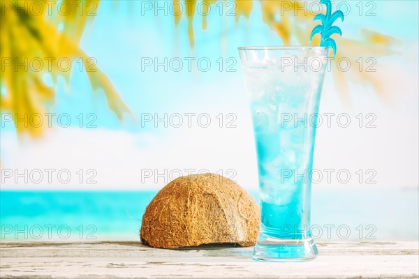 Glass cooling blue drink inverted coconut shell